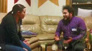 two people arguing on a sofa