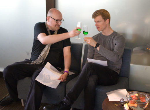 two people toasting with green drinks