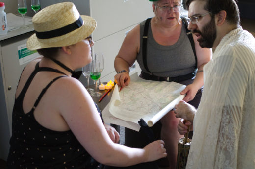 three people discussing over a map