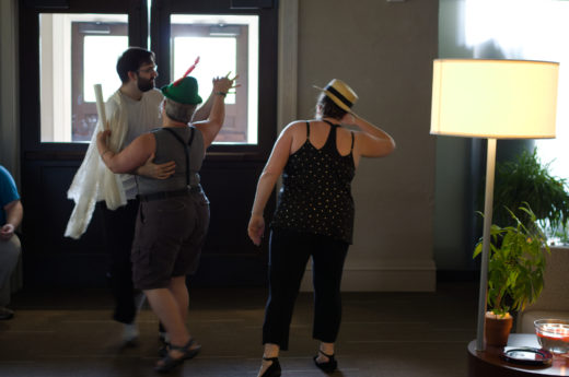 two people dancing while a third watches