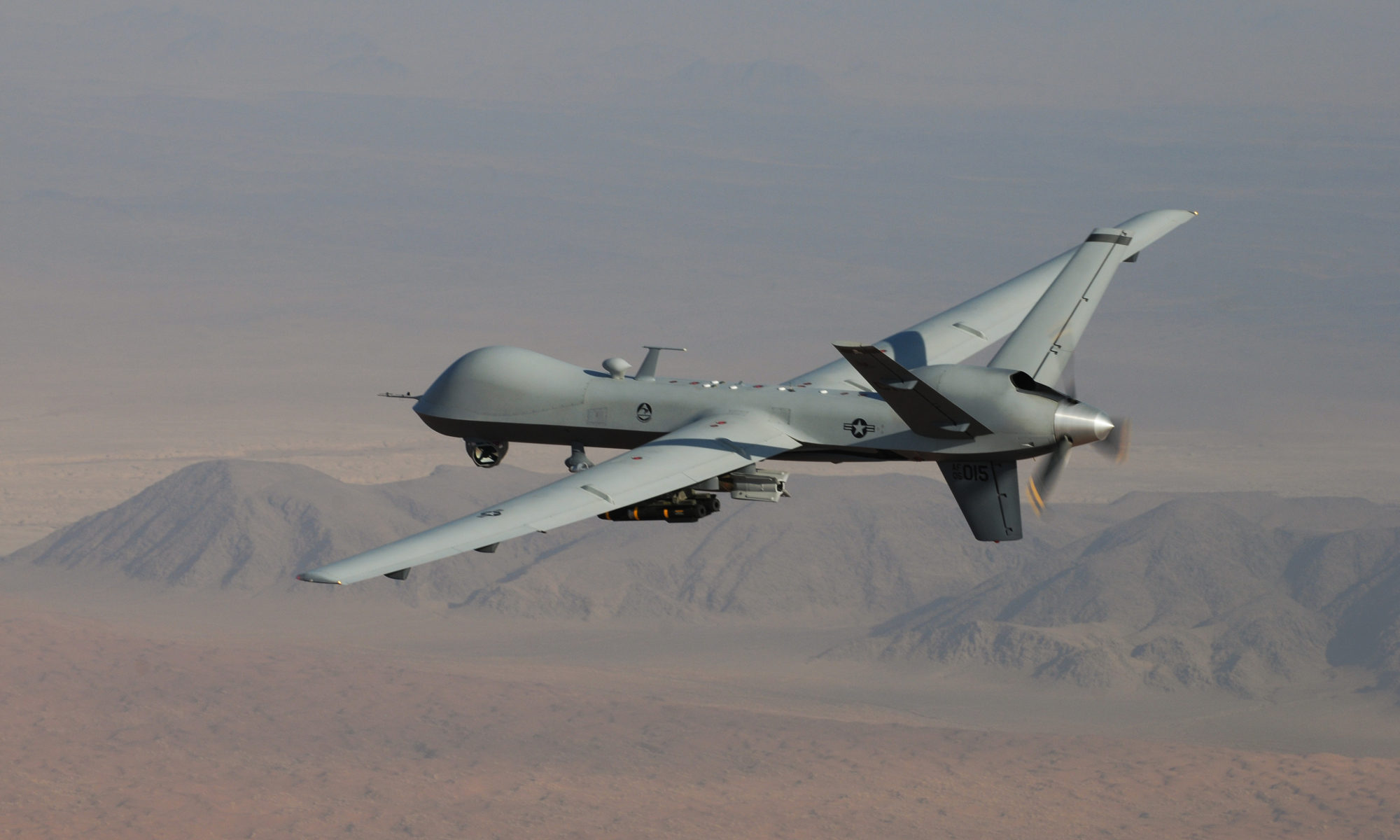 MQ-Q Reaper unmanned aircraft in flight over desert